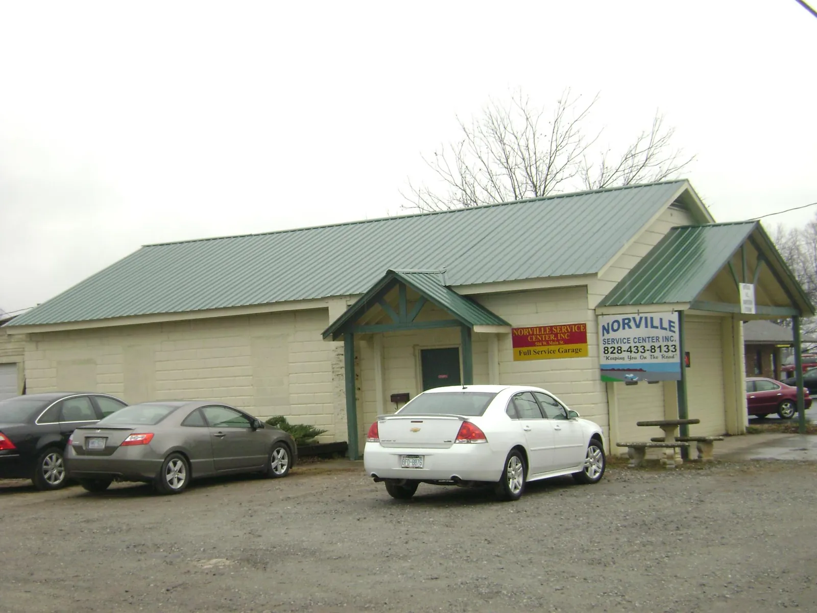 Green metal roof on a service garage with a covered entry in Palo